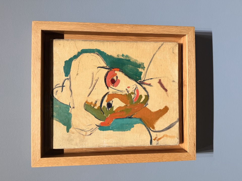 Exhibit A, twice. From across the room, a face. From two feet away, a committee of paint slabs that have never met.